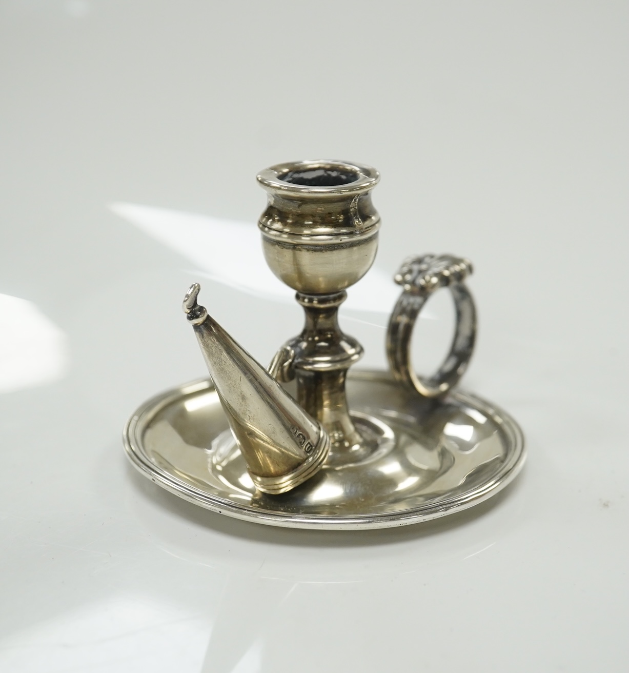 A George III miniature silver chamber stick, Emes & Barnard, London, 1815(a.f.), with matching snuffer, base diameter 75mm. Condition - poor